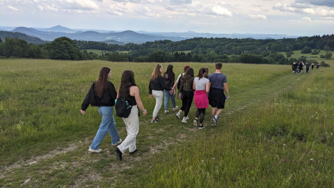 Man sieht verschiedene Jugendliche über einen Feldweg laufen